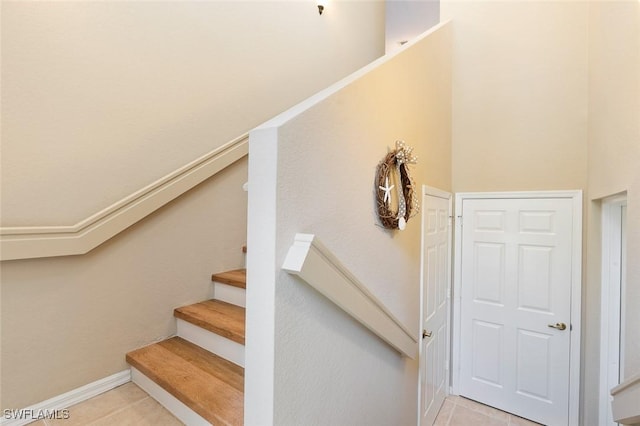 stairway with tile patterned flooring