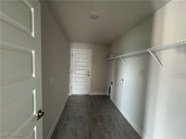 clothes washing area with wood finish floors, laundry area, electric dryer hookup, and baseboards