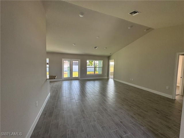 unfurnished living room with dark wood-style floors, baseboards, visible vents, and high vaulted ceiling