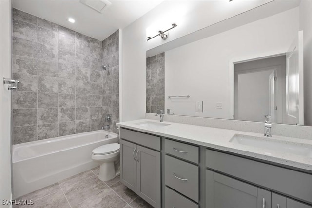 full bathroom with toilet, vanity, tile patterned floors, and tiled shower / bath