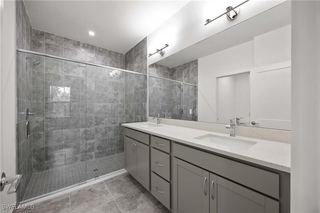 bathroom featuring tile patterned flooring, walk in shower, and vanity