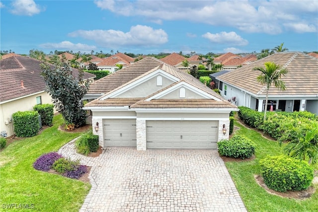 view of front of home with a garage and a front lawn