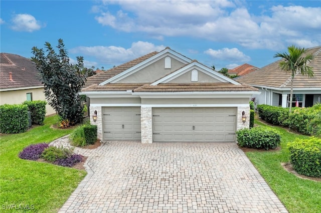 view of front of home featuring a garage and a front lawn