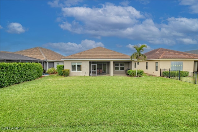 back of property featuring a lawn