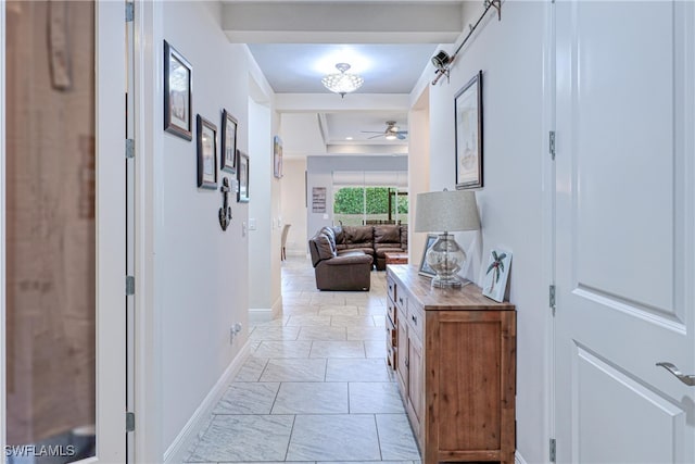 hallway with a raised ceiling