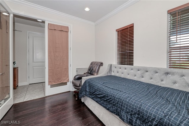 bedroom with crown molding and hardwood / wood-style floors