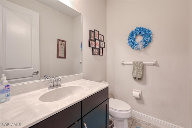 bathroom with vanity, toilet, and tile patterned flooring