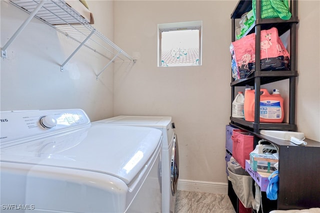 washroom with washing machine and clothes dryer