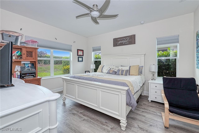 bedroom with wood-type flooring and ceiling fan