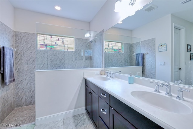 bathroom featuring vanity and tiled shower