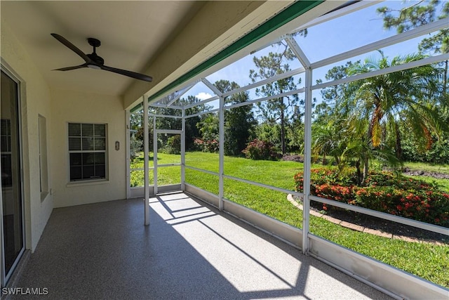 unfurnished sunroom with ceiling fan