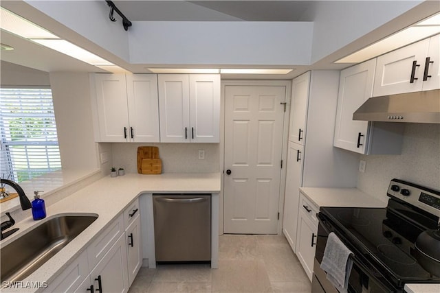 kitchen featuring white cabinets, appliances with stainless steel finishes, a sink, under cabinet range hood, and backsplash