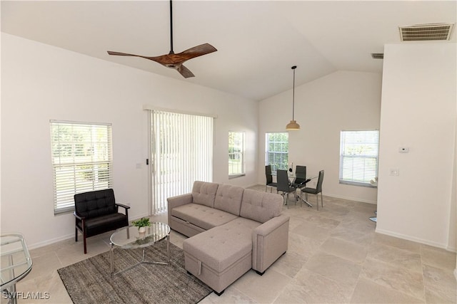 living room featuring baseboards, plenty of natural light, visible vents, and a ceiling fan