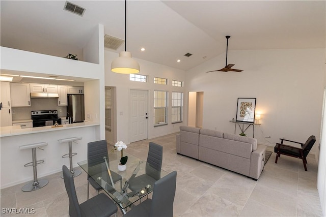 living room with high vaulted ceiling, visible vents, and recessed lighting