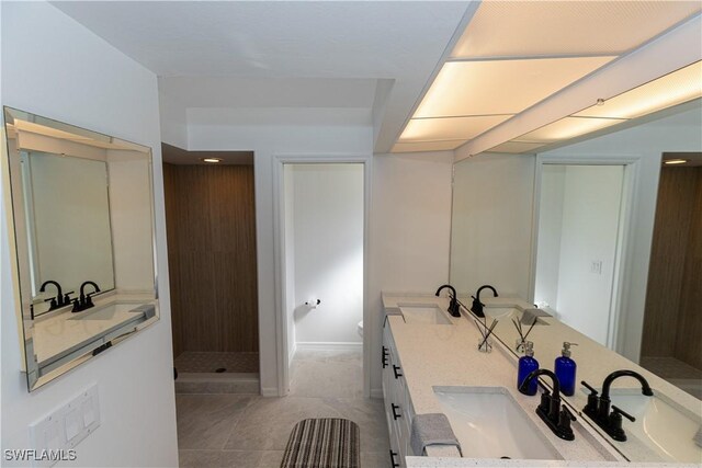 full bathroom featuring a walk in shower, a sink, and double vanity