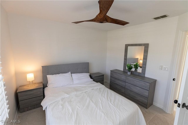 bedroom featuring ceiling fan, visible vents, and baseboards