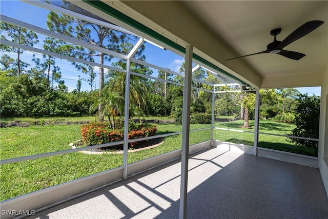 unfurnished sunroom with a ceiling fan