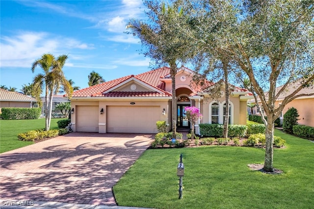 mediterranean / spanish-style home featuring a garage and a front lawn