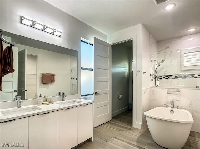 bathroom with plus walk in shower and vanity