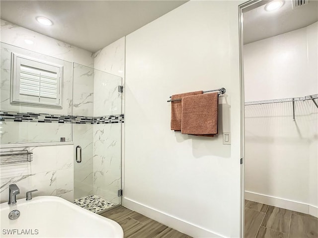 bathroom featuring a shower with door