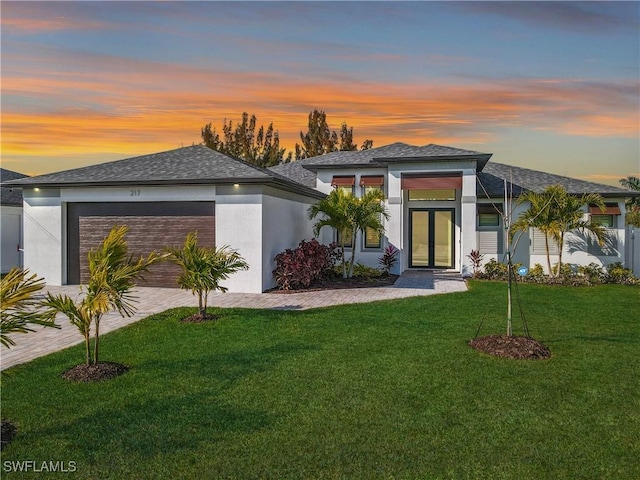 217 SW 21st St, Cape Coral, FL 33991 - prairie-style house featuring french doors, a yard, and a garage