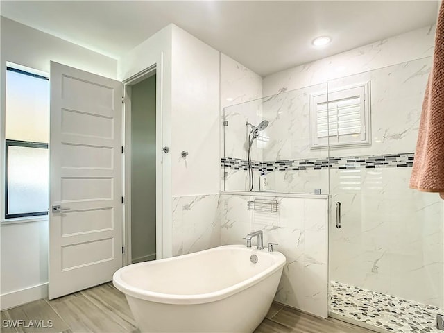 bathroom with separate shower and tub