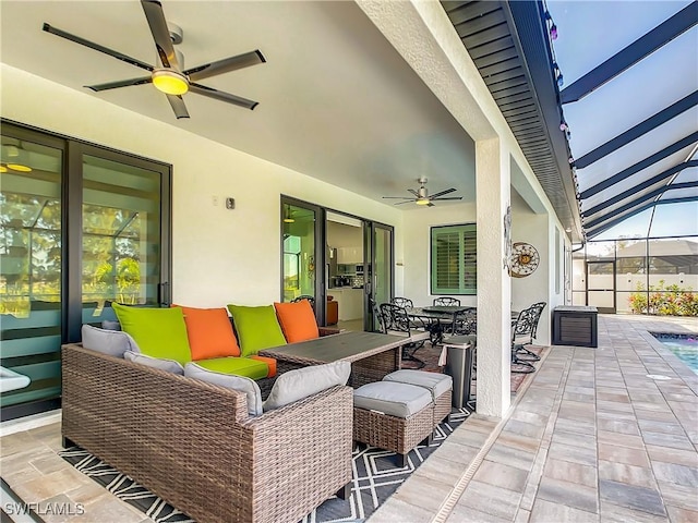 view of patio / terrace featuring a lanai, ceiling fan, and an outdoor living space