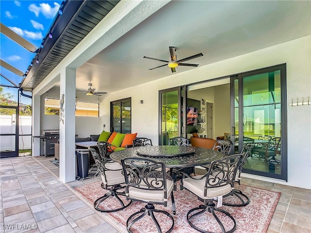 view of patio featuring a lanai and ceiling fan