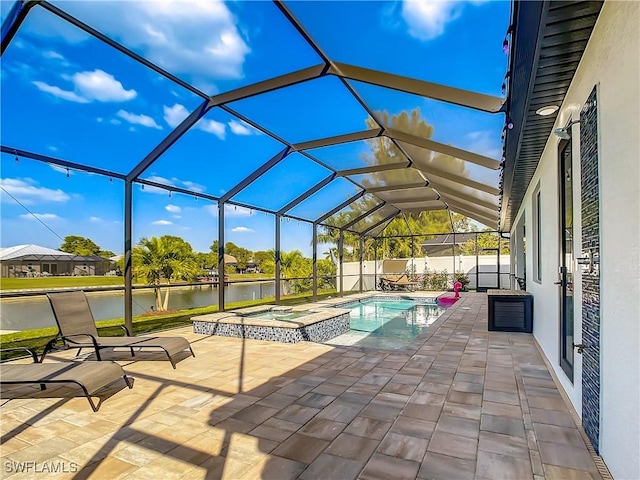 view of swimming pool with a water view, a patio, glass enclosure, and an in ground hot tub