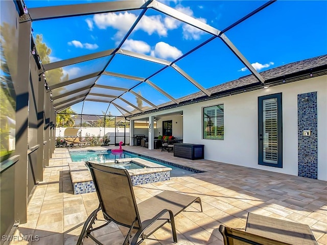 view of pool with a lanai, an in ground hot tub, and a patio