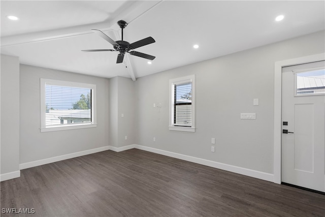 spare room featuring ceiling fan, beam ceiling, and dark hardwood / wood-style flooring