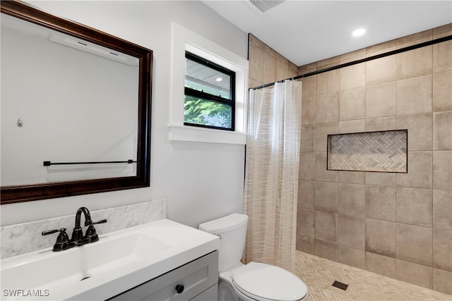 bathroom with toilet, vanity, and a shower with shower curtain