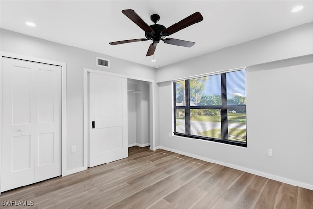 unfurnished bedroom featuring ceiling fan and light wood-type flooring