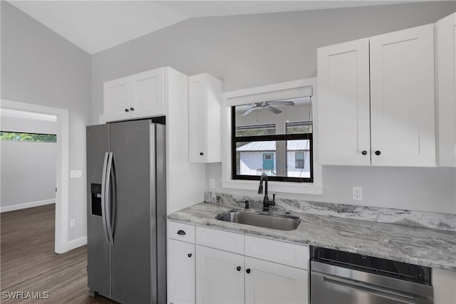 kitchen with white cabinetry, ceiling fan, stainless steel appliances, vaulted ceiling, and sink