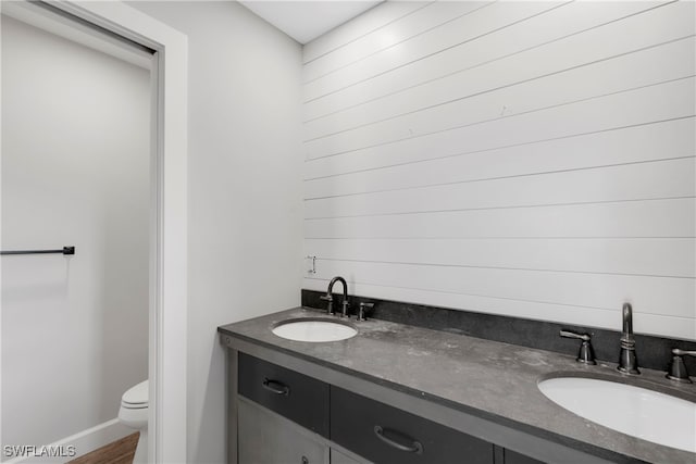 bathroom featuring toilet, vanity, and wood-type flooring