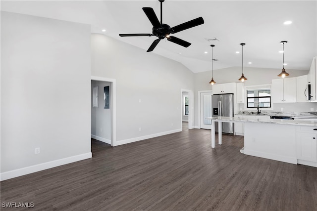 kitchen with ceiling fan, pendant lighting, white cabinets, and stainless steel fridge