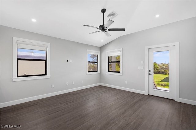 unfurnished room with vaulted ceiling, ceiling fan, a wealth of natural light, and dark hardwood / wood-style floors