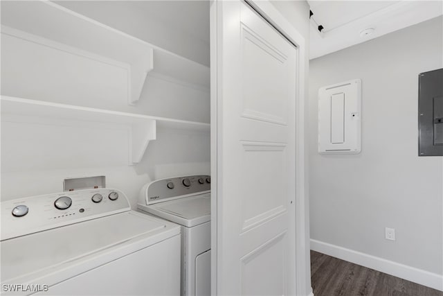 washroom featuring separate washer and dryer, electric panel, and dark hardwood / wood-style flooring