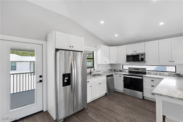 kitchen with sink, white cabinetry, lofted ceiling, and stainless steel appliances