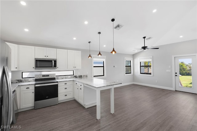 kitchen featuring pendant lighting, lofted ceiling, white cabinetry, stainless steel appliances, and kitchen peninsula