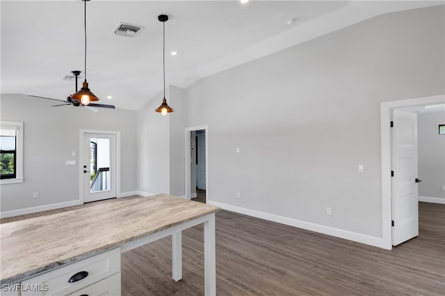 kitchen with white cabinetry, ceiling fan, dark hardwood / wood-style flooring, vaulted ceiling, and pendant lighting