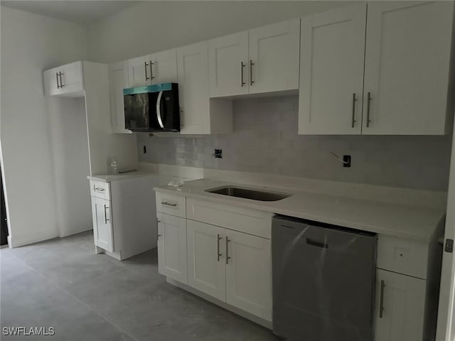 kitchen featuring sink, backsplash, white cabinets, and dishwasher