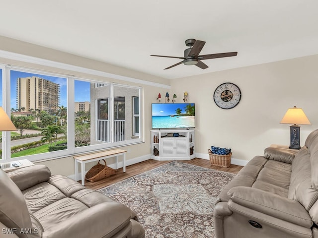 living room featuring hardwood / wood-style floors and ceiling fan