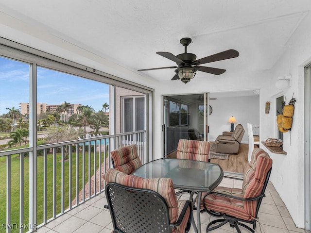 sunroom / solarium featuring ceiling fan