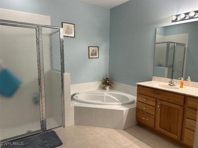 full bath with a stall shower, vanity, a bath, and tile patterned floors