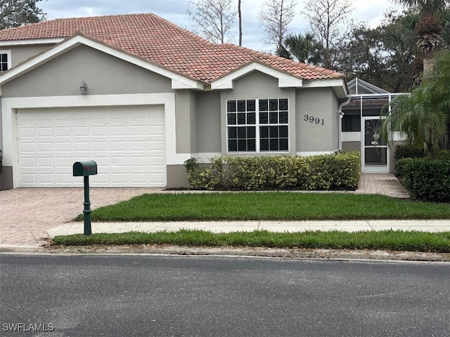 view of front of home with glass enclosure, driveway, a tiled roof, and stucco siding