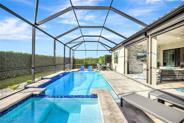 view of pool featuring a lanai, an outdoor living space, and a patio