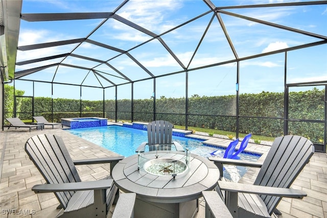 view of swimming pool featuring pool water feature, glass enclosure, an in ground hot tub, and a patio