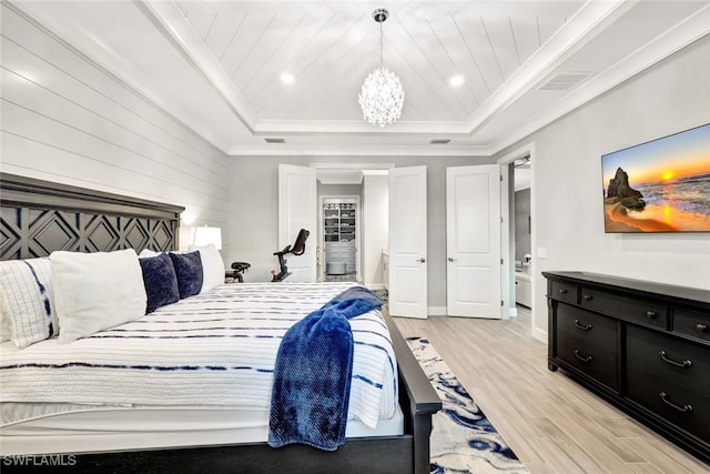 bedroom featuring wood ceiling, light hardwood / wood-style floors, ornamental molding, a raised ceiling, and a chandelier