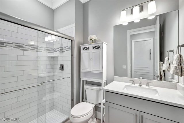 bathroom featuring an enclosed shower, vanity, and toilet